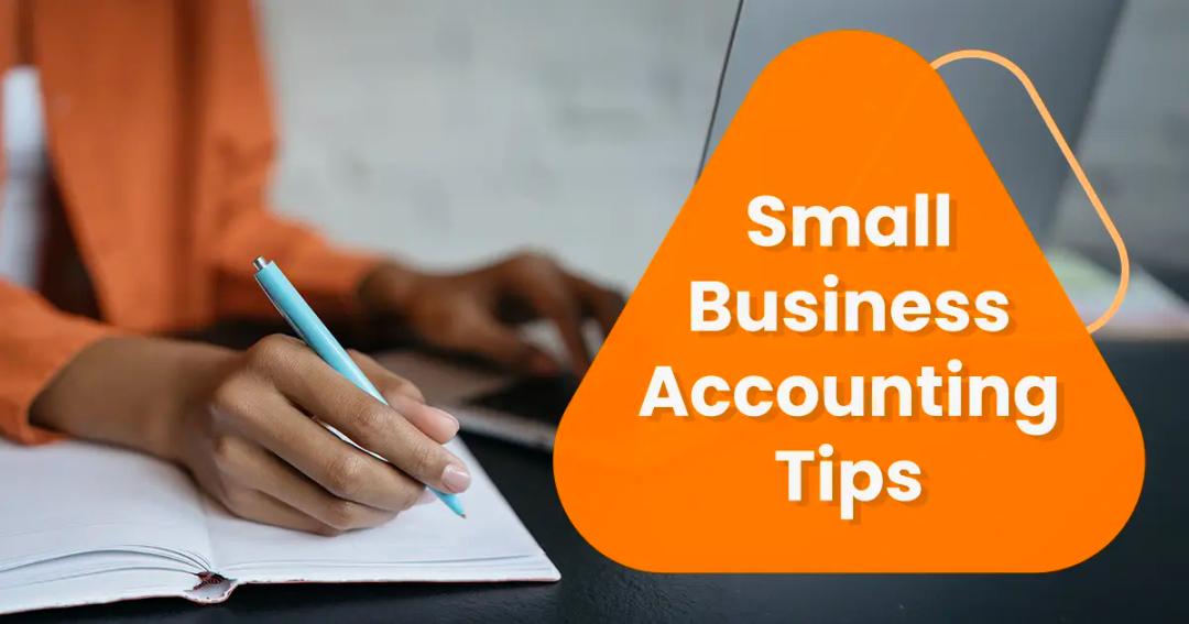 A person writes in a notebook while holding a pen. An orange triangle with text reading "Small Business Accounting Tips" is displayed to the right side.